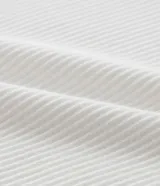 Musculosa blanca de rib con textura acanalada, escote cuadrado y breteles medianos. Confeccionada en algodón certificado BCI y elastano.