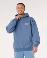 Canguro con capucha Rip Curl modelo Surf Puff Hood, color azul, con estampa en la espalda con el texto 'Ripcurl Surfing Company Since 1969' en color naranja.