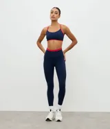 Legging deportiva Get Over de tiro alto, color azul marino con detalle de cintura elástica en color rojo. Confeccionada en tejido de microfibra elástica.