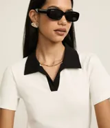 Blusa de manga corta confeccionada en tejido acanalado de algodón con elastano, de color bordó con cuello polo en tono amarillo claro y escote en V.