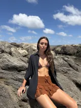 Short tejido a crochet color marrón con volados en el ruedo y cordón ajustable en la cintura.