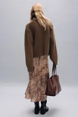 Jersey de punto en mezcla de lana color marrón, con cuello subido, manga larga y terminaciones en rib.