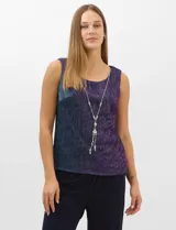 Conjunto de tres piezas compuesto por una musculosa recta, un cardigan liviano de frente abierto con mangas 3/4 y un pantalón de seda fría. La musculosa y el cardigan están confeccionados en tejido plisado con hilos metalizados tornasolados. Incluye collar removible y forro interno a tono.