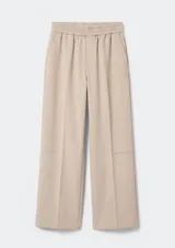 Pantalón de corte recto y tiro medio, color beige, con cintura elástica y bolsillos laterales.