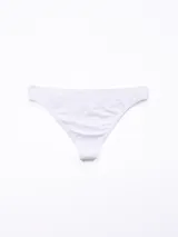 Colaless blanca de tejido liso, sin costuras (seamless), con corte bajo y tiro bajo.