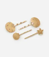 Kit de cuatro pinzas para el pelo en color dorado, con diseños de caracolas y estrella de mar. Algunas piezas presentan incrustaciones de cristales brillantes.