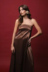 Vestido largo strapless color marrón con efecto tornasolado y bolsillos ocultos.