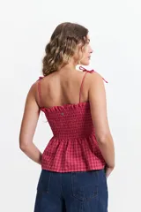 Blusa de algodón a cuadros color celeste y rosado, con escote recto, breteles finos y fruncido en el cuerpo.