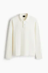 Remera polo de manga larga H&M en punto jacquard de mezcla de algodón, con cuello clásico, tapeta con botones y corte ajustado.