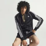 Campera deportiva Adidas Originals de corte clásico, confeccionada en tejido satinado negro. Presenta cierre frontal completo, cuello alto, puños y ruedo acanalados, y las icónicas tres tiras blancas en las mangas. Incluye el logo del trébol bordado en el pecho.