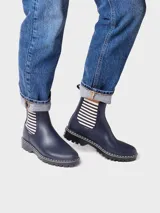 Botas de agua de caña baja color bordó, con elásticos laterales a rayas en tonos burdeos, beige y marrón. Cuenta con suela dentada negra, costuras blancas decorativas en el borde y presilla trasera para facilitar el calce.
