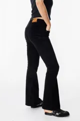 Pantalón de pana color beige, de corte acampanado y tiro medio, con cierre frontal y bolsillos laterales.