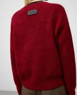 Jersey de punto para mujer, color rojo oscuro, con cuello en V y manga larga. Presenta un acabado afelpado y holgado, con remates en canalé.