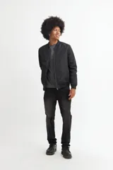 Campera bomber negra de poliéster con cierre frontal y cuello redondo.