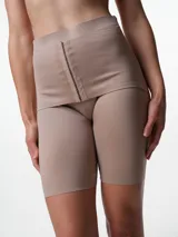 Short modelante de tiro alto confeccionado en microfibra, diseñado para brindar contención y compresión en la zona abdominal. Presenta cierre frontal con ganchos y silicona antideslizante en el borde interno para un ajuste seguro.