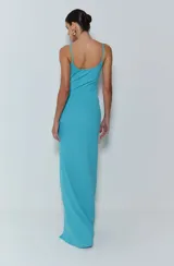 Vestido largo de punto canalé color celeste, con tirantes finos, corte entallado, abertura lateral y doble abertura en la cintura.