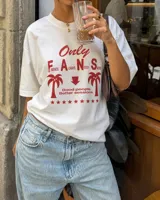 Remera oversize de color beige con estampa frontal en marrón, mangas cortas y cuello redondo.