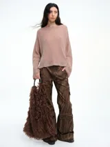 Sweater de punto negro con lentejuelas sutiles, de corte holgado, hombros caídos y mangas largas con terminación acampanada.