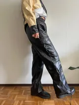 Pantalón cargo negro de cuero sintético, corte holgado, cintura elastizada y bolsillos laterales con solapa.