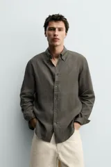Camisa celeste de lino de corte regular fit, con cuello abotonado, manga larga y cierre frontal de botonadura.
