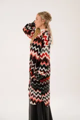 Tapado largo de lana con estampado zigzag horizontal en tonos rojo, negro, blanco y gris. De manga larga y abotonado.