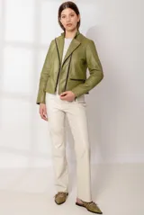 Chaqueta de cuero ovino estilo motoquera, color verde oliva, con cierre frontal cruzado, bolsillos horizontales con cierre y detalles de acolchado en hombros y codos.