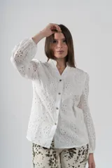 Camisa blanca de algodón con bordados perforados y botones de madera.