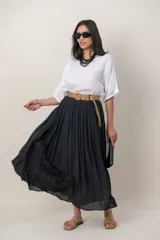 Pollera larga de color marrón, confeccionada en tela liviana con textura sutil y diseño plisado. Incluye un cinto rústico trenzado.