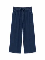 Pantalón de jean azul oscuro, de corte ancho y relajado, con cintura elástica fruncida y cordón ajustable.