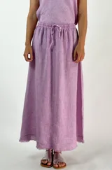 Pollera larga de lino color lila, con cintura elastizada y cordón ajustable.