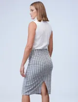 Falda tubo de largo hasta la rodilla, con estampado pata de gallo en blanco y negro. Presenta cintura elastizada y un tajo en la parte trasera.