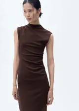 Vestido midi de color marrón, sin mangas, con cuello perkins y diseño entallado. Presenta un detalle drapeado en la cintura.