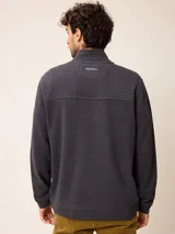 Buzo de abrigo azul melange con cierre frontal completo, cuello alto y bolsillos laterales, confeccionado en mezcla de algodón y poliéster.