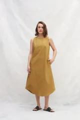 Vestido midi color beige de lino, sin mangas y con escote redondo.
