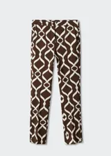Pantalon skinny crop de tiro medio con diseño estampado geométrico en tonos marrón y blanco. Cuenta con trabillas, bolsillos laterales, bolsillos de ribete traseros y cierre de cremallera con botón.