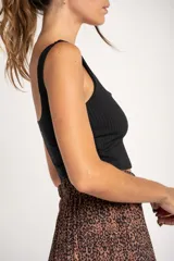 Top negro de viscosa con textura acanalada, corte ajustado y breteles anchos.