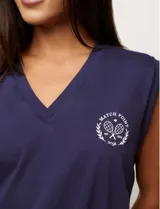 Musculosa blanca con cuello en V y logo bordado en el pecho.