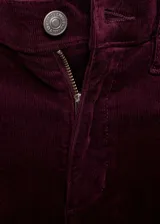 Pantalón de pana estilo flare con tiro alto, cierre de cremallera y botón, trabillas y diseño de cinco bolsillos.