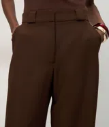 Pantalón de sastrería corte recto, color marrón, con cintura de tiro medio, trabillas largas y bolsillos traseros.