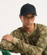Gorra de ala curva en sarga de algodón negro, con bordado frontal "NY" al tono y cierre ajustable en la parte trasera.