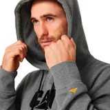 Buzo canguro gris melange con capucha y cordones de ajuste negros. Cuenta con bolsillo frontal tipo canguro y el logotipo de Caterpillar bordado en el pecho en color negro.