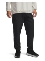 Pantalón deportivo Under Armour Unstoppable Tapered color negro, de corte ajustado en la pierna, confeccionado con tejido elástico y tecnología UA Storm repelente al agua.