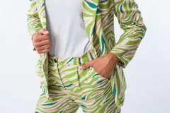 Pantalón de vestir con estampado abstracto en tonos verde, rosa y celeste.