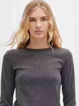 Remera de manga larga con cuello a la base, confeccionada en tejido acanalado con calce al cuerpo y diseño tipo crop.