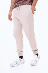 Pantalón de felpa con cintura elástica ajustable mediante cordón, bolsillos laterales y puños acanalados en los tobillos.