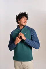 Buzo de cuello alto con cierre frontal parcial, diseño bicolor con cuerpo en verde y mangas raglán en azul. Presenta el logo de la marca bordado en el pecho.
