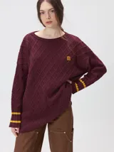 Sweater de punto con diseño de rombos en relieve, cuello redondo y calce holgado. Presenta aberturas laterales en el ruedo y logo bordado en el pecho.