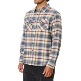 Camisa de franela a cuadros en tonos beige, azul y marrón, con cierre frontal de botones, bolsillos en el pecho con solapa y botones, manga larga y dobladillo redondeado.