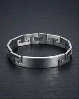 Pulsera rígida de acero inoxidable con diseño de guarda griega en los extremos y placa central lisa apta para grabado.