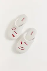 Pantuflas de tela waffle color blanco con bordados de labios rojos y la frase 'kiss me'.